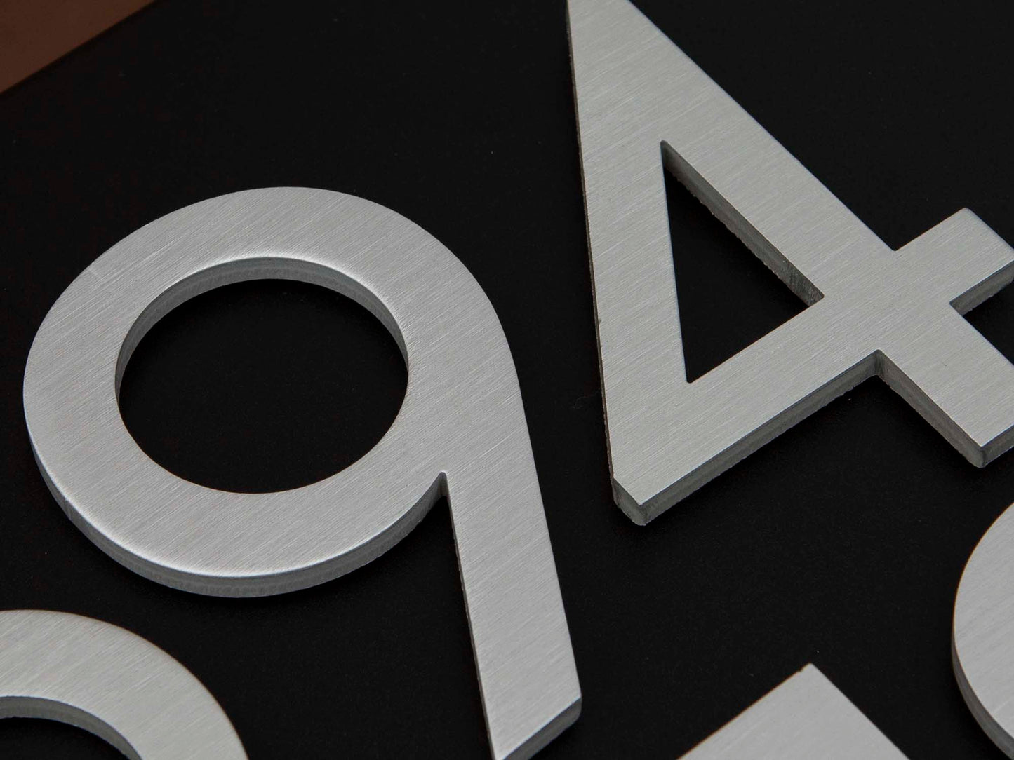 Close-up detail of brushed metal address numbers on HC120 mailbox