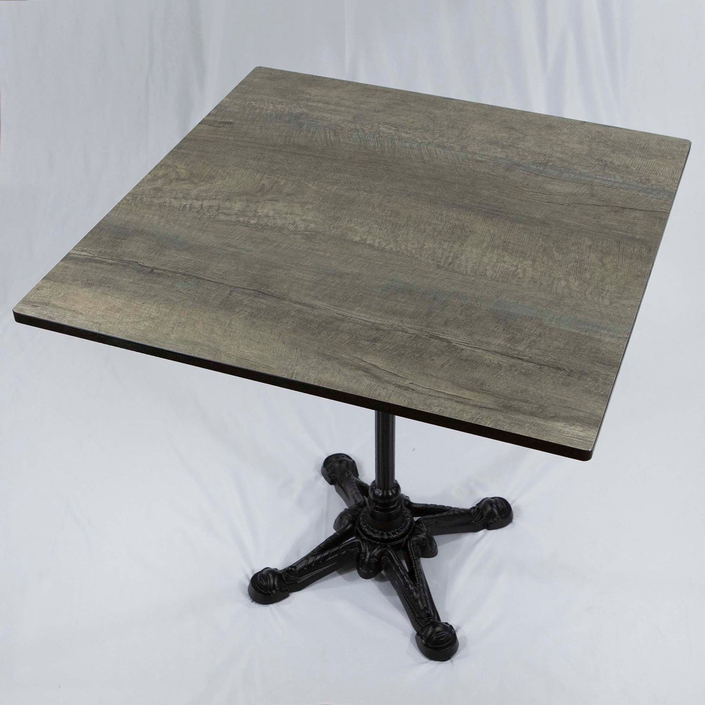 Small square table with a wooden top and metal base on a white background