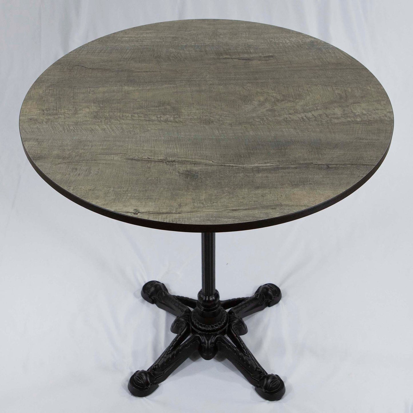 Round wooden table with a black metal base on a white background