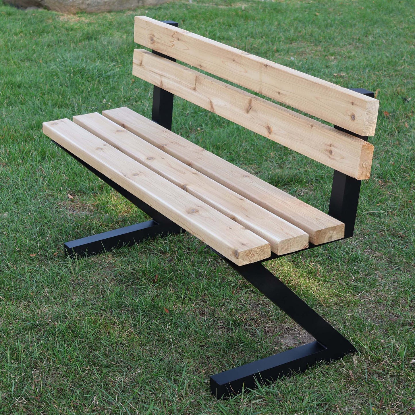 A015 outdoor wooden bench supported by black zig zag aluminum legs with integrated backrest