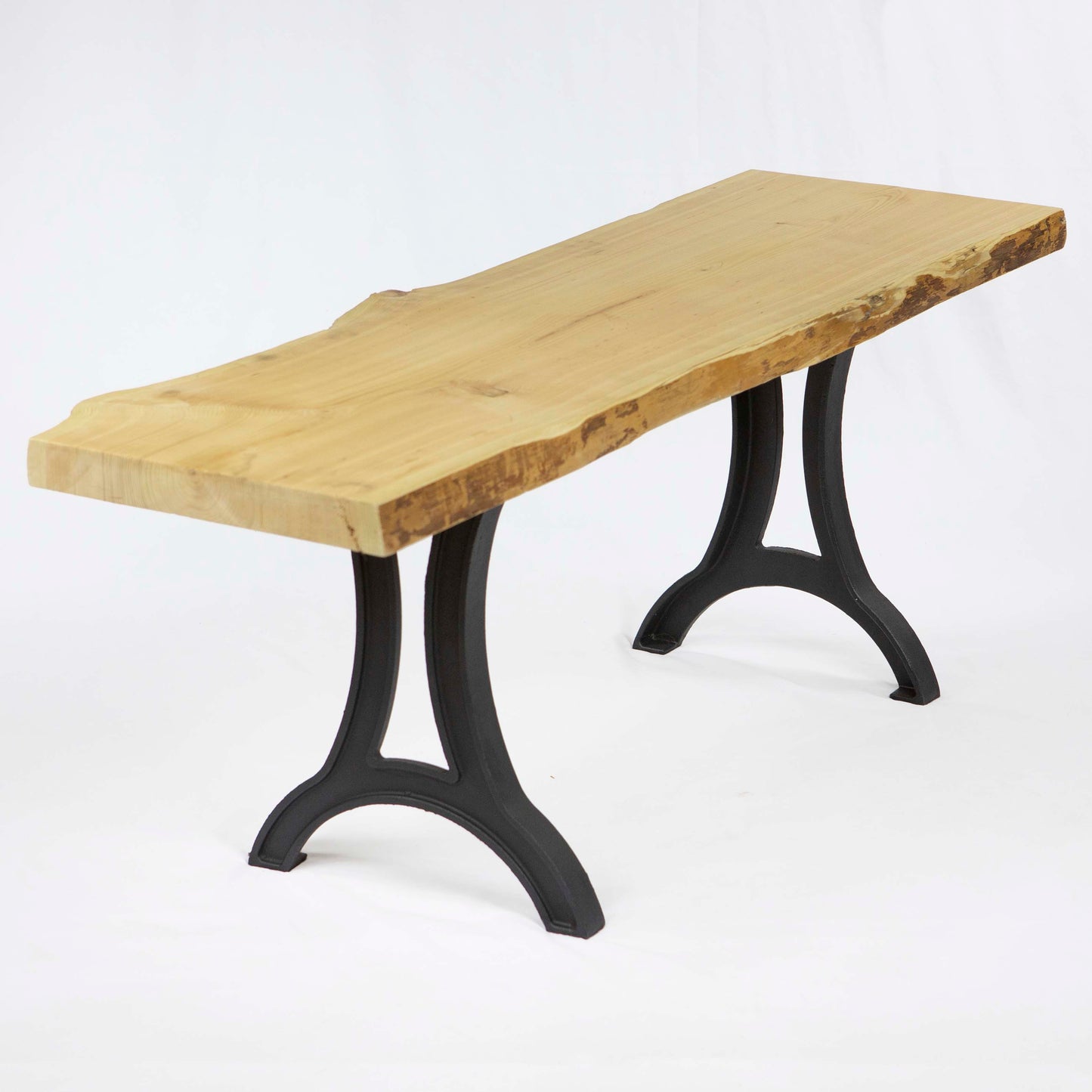 Cast iron bench legs installed with solid wood bench seat, rustic industrial bench design