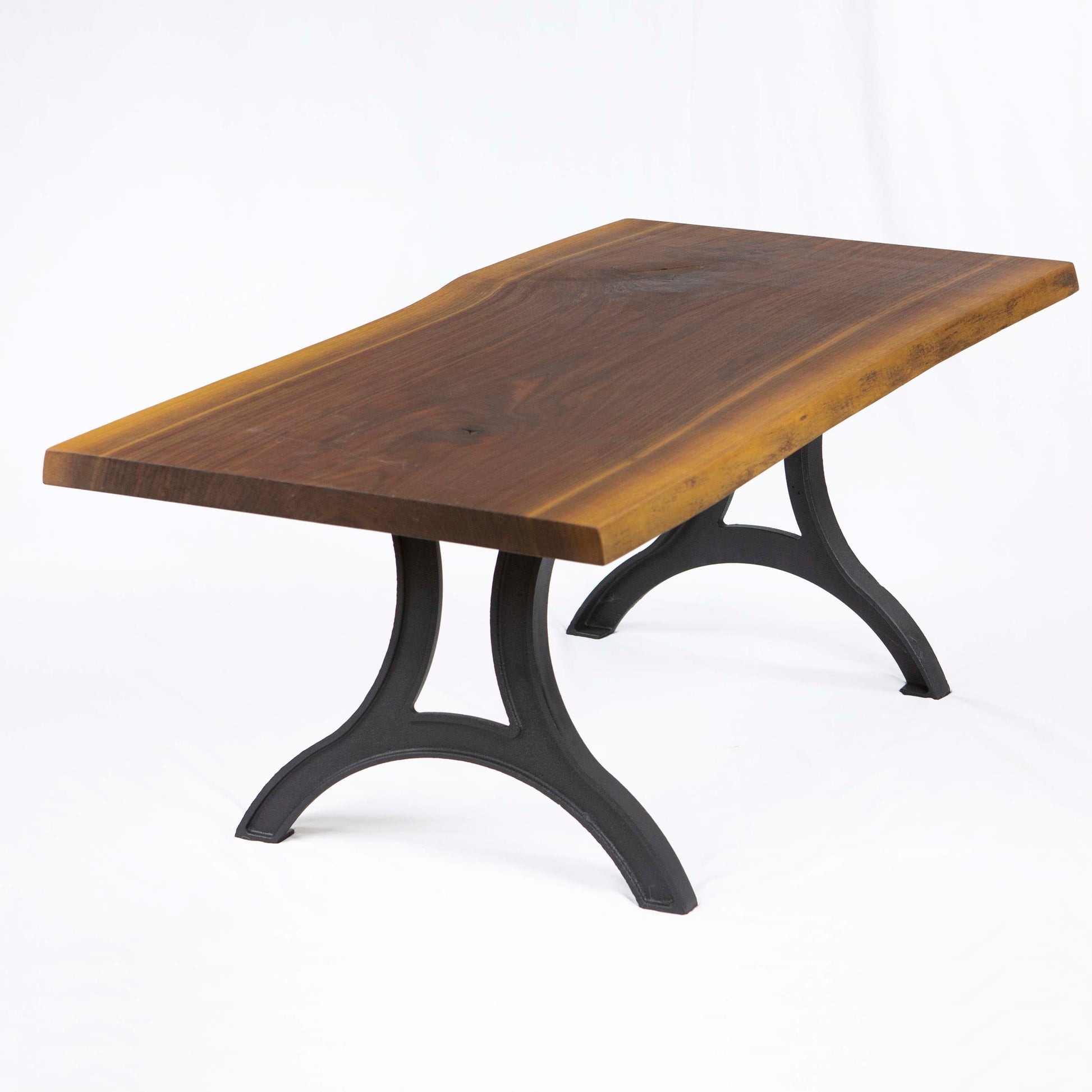Cast iron coffee table legs installed with solid wood tabletop, rustic industrial coffee table design