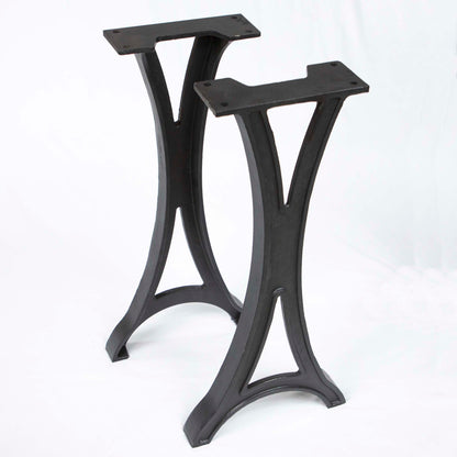 Black cast iron console table legs with elegant curved shape and flat mounting plates, isolated on white backgroundlegs