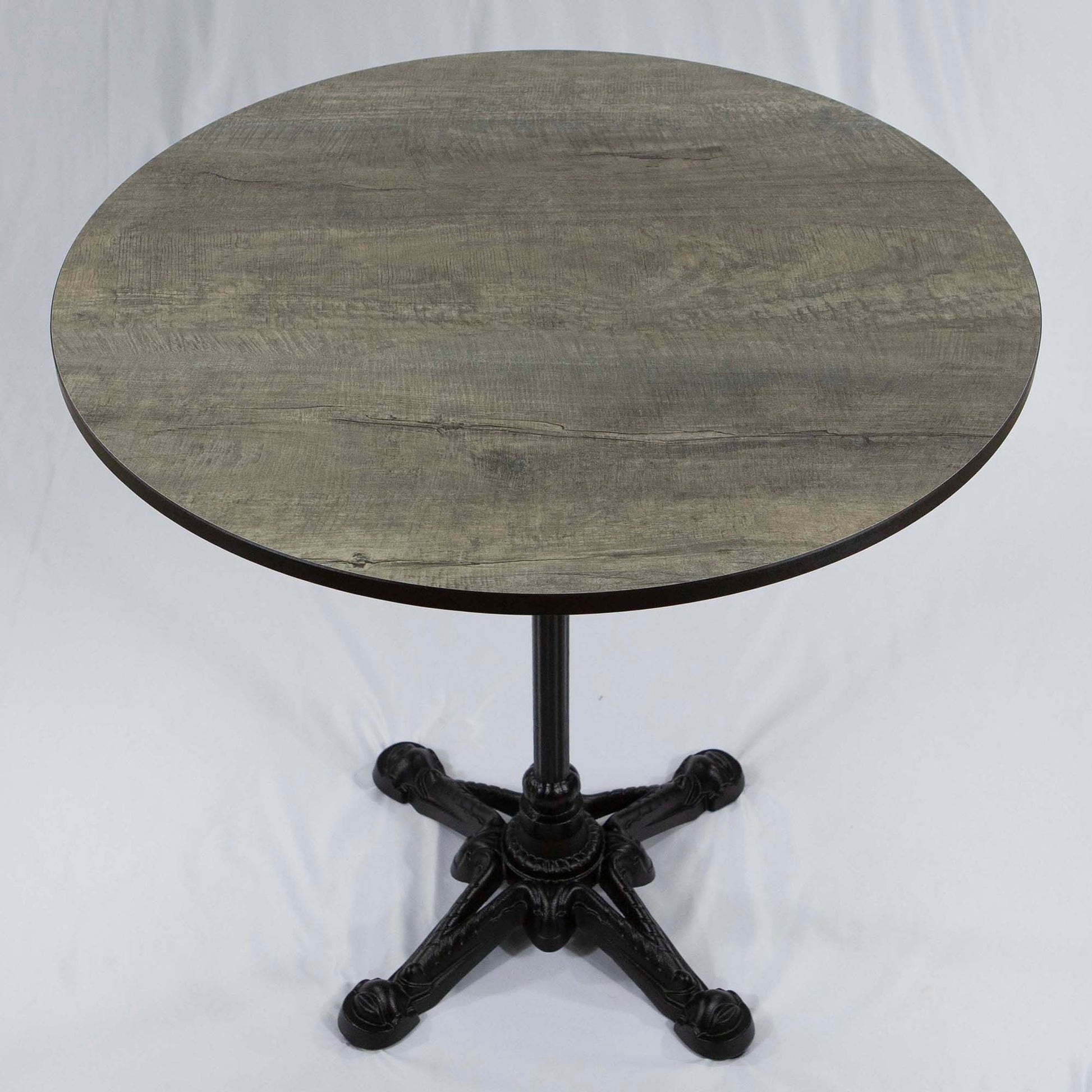 Round wooden table with a black metal base on a white background