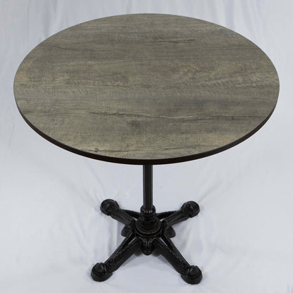 Round wooden table with a black metal base on a white background