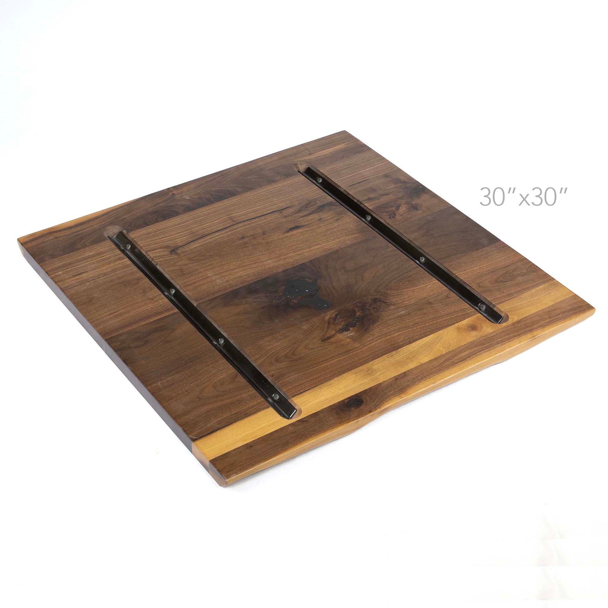 underside of square black walnut tabletop with steel reinforcement channels
