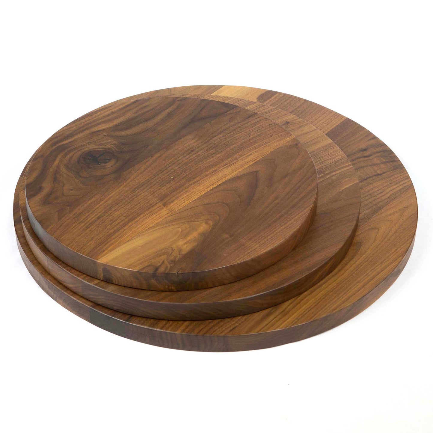 stacked round black walnut tabletops showing different size options