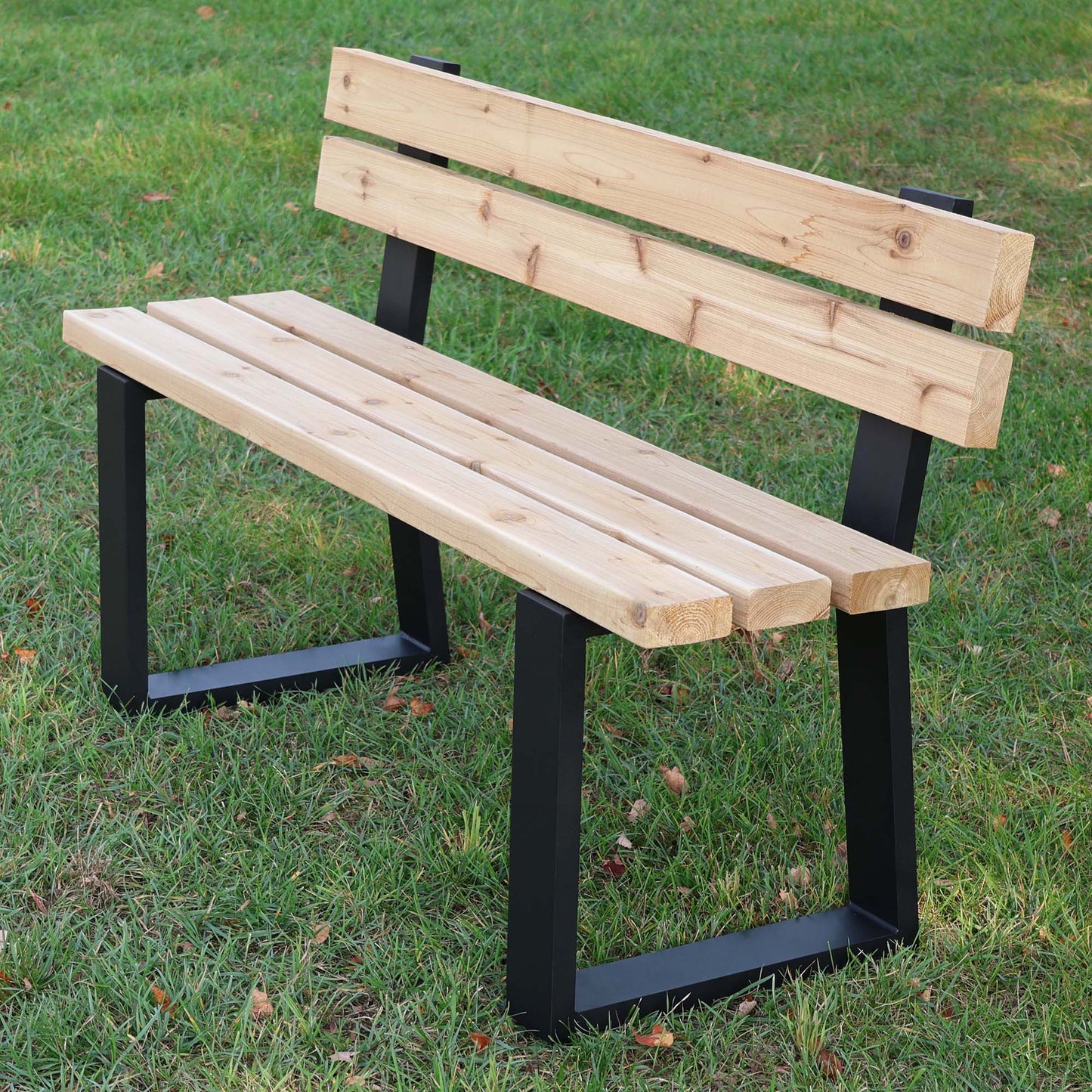Rusty Design trapezoid aluminum bench legs with backrest supporting a wooden outdoor bench