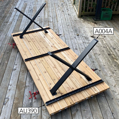 Rusty Design black wishbone table base installed under a solid wood dining table